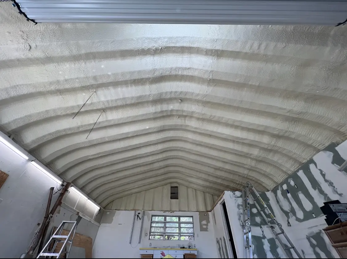 Spray polyurethane foam applied to the underside of a metal roof deck in Derby